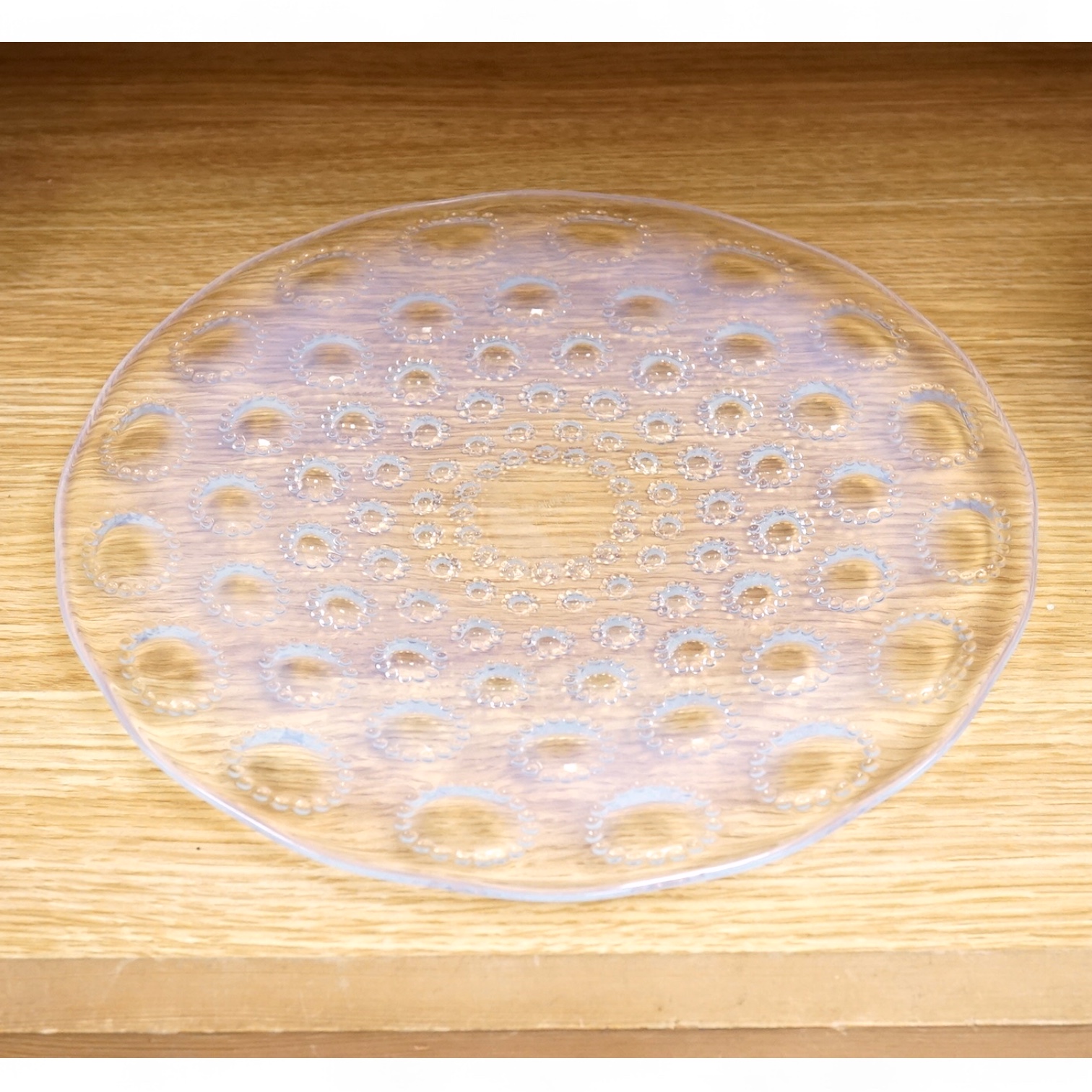 A Lalique Asters coupe-ouverte glass dish, etched R. Lalique France to the base, 28cm in diameter